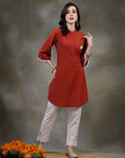 Rust cotton kurti with floral embroidery and lace-trimmed bell sleeves