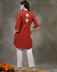 Rust cotton kurti with floral embroidery and lace-trimmed bell sleeves