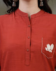 Rust cotton kurti with floral embroidery and lace-trimmed bell sleeves