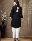 Black cotton kurti with floral embroidery and lace-trimmed bell sleeves