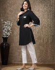 Black cotton kurti with floral embroidery and lace-trimmed bell sleeves